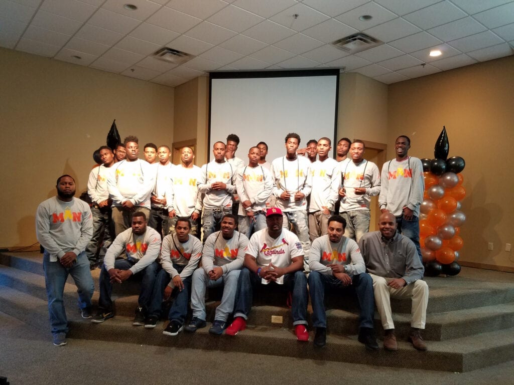 A group of men in white shirts and jeans.