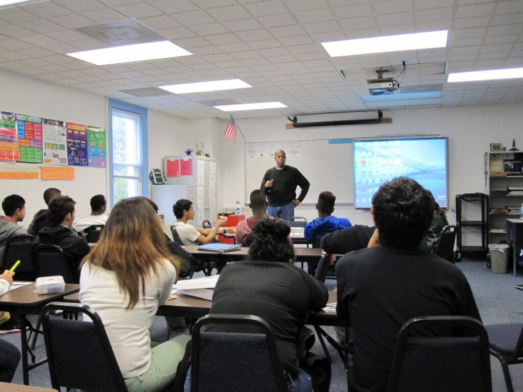 A man standing in front of a class room